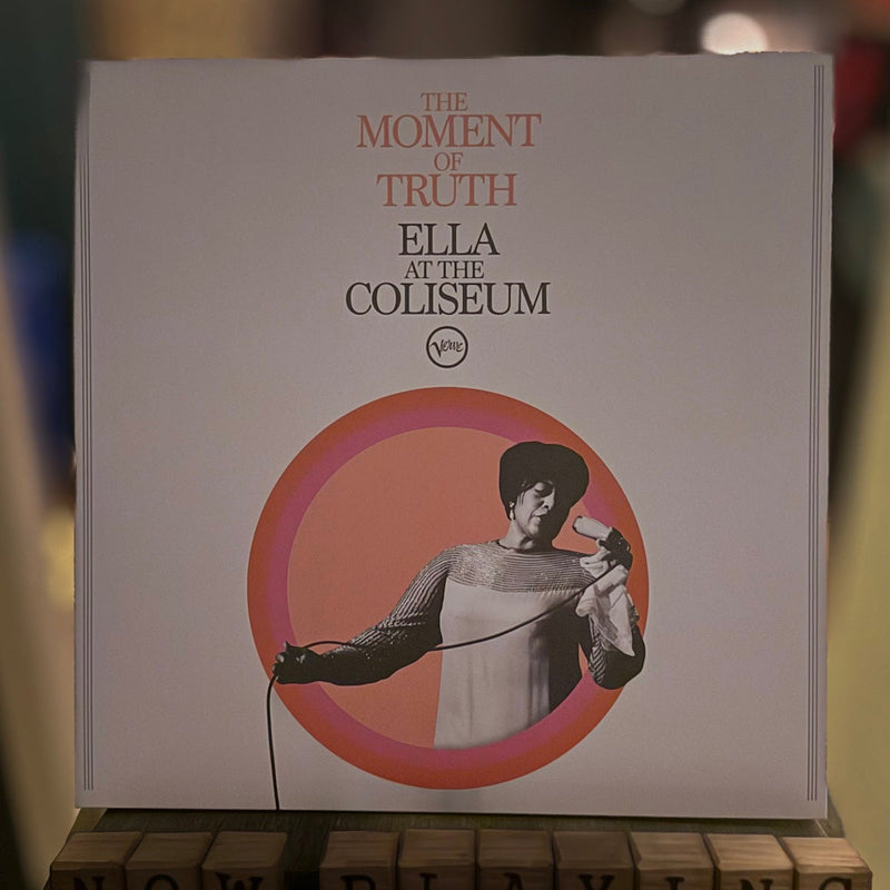 Album cover of 'The Moment of Truth: Ella at the Coliseum' with a blurred background.