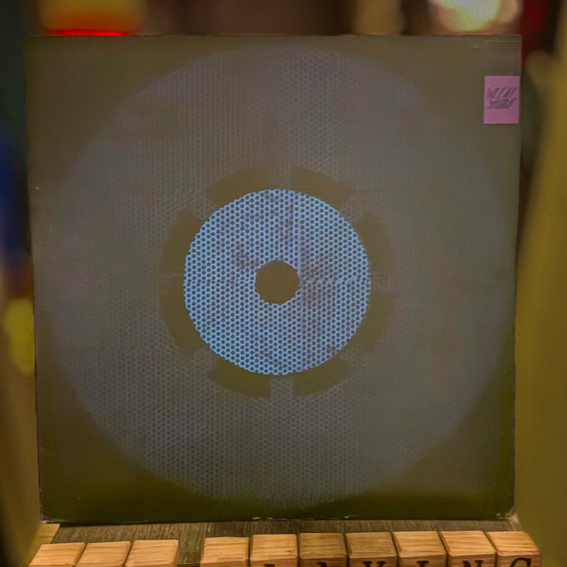 Music player with a blue display and 'Now Playing' text on wooden blocks.